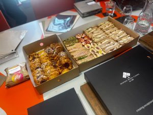 Sandwich platters and a sample box on the table at the FKM lunch and learn